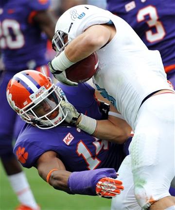 (AP Photo/Rainier Ehrhardt, File). FILE - In this Nov. 23, 2013, file photo, Clemson defensive back Martin Jenkins (14) stops The Citadel's Dalton Trevino during the second half of an NCAA college football game in Clemson, S.C.  Jenkins has filed lawsu...