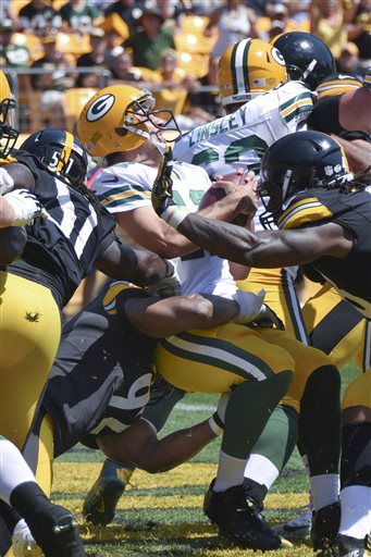 (AP Photo/Don Wright). Green Bay Packers quarterback Aaron Rodgers (12) is sacked by Pittsburgh Steelers outside linebacker James Harrison (92), bottom, for a safety in the first quarter of the NFL pre-season football game, Sunday, Aug. 23, 2015 in Pit...