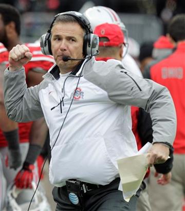 (AP Photo/Jay LaPrete, File). FILE - In this Nov. 29, 2014, file photo, Ohio State head coach Urban Meyer reacts to an Ohio State touchdown against Michigan during the fourth quarter of an NCAA college football game in Columbus, Ohio. The first matchup...