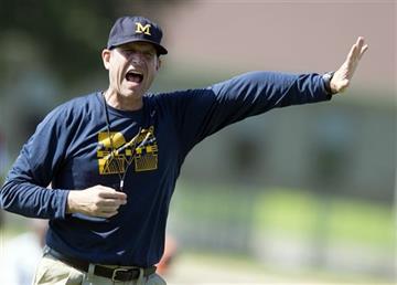(Albert Cesare/The Montgomery Advertiser via AP). Michigan football coach Jim Harbaugh yells during the Coach Jim Harbaugh's Elite Summer Football Camp, Friday, June 5, 2015, at Prattville High School in Prattville, Ala. Harbaugh will have to improve t...