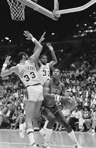 (AP Photo/Doug Pizac, File). FILE - In this June 4, 1982, file photo, Philadelphia 76ers' Darryl Dawkins, right, tries rto get past the defense ofliterally is swamped by the defense of the Loa Angeles Lakers Kareem Abdul-Jabbar (33) and Earvin Magic Jo...