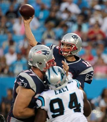 (AP Photo/Chuck Burton). New England Patriots' Tom Brady (12) looks to pass under pressure from Carolina Panthers' Kony Ealy (94) during the first half of an NFL preseason football game in Charlotte, N.C., Friday, Aug. 28, 2015.