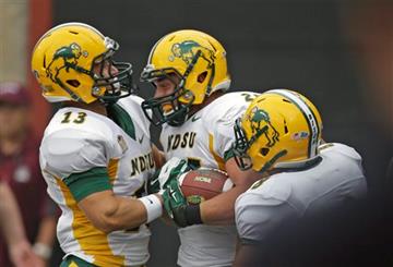 (AP Photo/Rick Bowmer). North Dakota State's running back Chase Morlock, center, celebrates with teammates Eric Perkins (13) and Darius Anderson (8)  scores during the first half of an NCAA college football game against Montana Saturday, Aug. 29, 2015,...