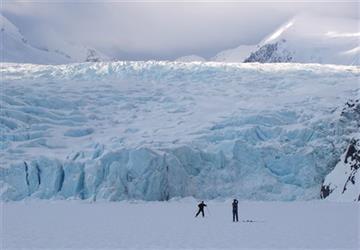 (Evan R. Steinhauser/Anchorage Dispatch News via AP, File). In this March 29, 2006 photo, a skier poses for a photograph on Portage Lake in front of Portage Glacier, about 50 miles south of Anchorage, Alaska. The Portage Glacier, which is a major Alask...