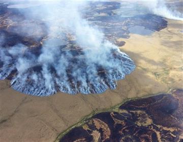 (Matt Snyder/Alaska Division of Forestry via AP, File ). FILE - In this Sunday, June 7, 2015 file photo provided by the Alaska Division of Forestry, smoke rises from the Bogus Creek Fire, one of two fires burning in the Yukon Delta National Wildlife Re...