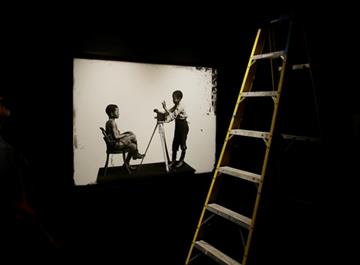(AP Photo/Stephan Savoia). In this Thursday, Aug. 27, 2015 photo, an 1891 portrait of Albert Jones and John Xiniwe, sitting for an unknown photographer for the London Stereoscopic Company, is displayed with other portraits made in studios across Britai...