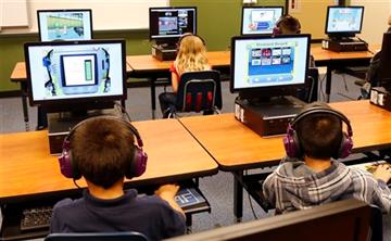(AP Photo/Sue Ogrocki,File). FILE - In this July 21, 2014 file photo, students at a summer reading academy at Buchanan elementary school work in the computer lab at the school in Oklahoma City. Results for some of the states that participated in Common...