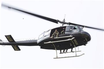 (Stacey Wescott/Chicago Tribune via AP). A police helicopter patrols a swampy area near route 59 and Rollins in Fox Lake, Ill.,  where a manhunt is in progress after an officer was shot on Tuesday, Sept. 1, 2015.  Lake County Major Crimes Task Force Cm...