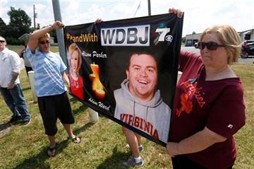 (AP Photo/Steve Helber). Local residents Hunter Cregger, left, and his mother Sandra Cregger, show their support for WDBJ-TV cameraman Adam Ward at the Blue Ridge Memorial Garden cemetery in Roanoke, Va., Tuesday, Sept. 1, 2015. Ward and WDBJ-TV mornin...