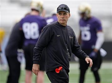 (AP Photo/Ted S. Warren, File). FILE - In this March 30, 2015, file photo, Washington coach Chris Petersen watches NCAA college football practice in Seattle. Washington plays Idaho, a team Petersen formerly coached, on Friday, Sept. 4.