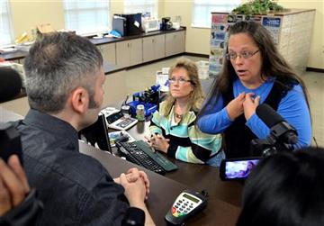 (AP Photo/Timothy D. Easley). Rowan County Clerk Kim Davis, right, talks with David Moore following her office's refusal to issue marriage licenses at the Rowan County Courthouse in Morehead, Ky., Tuesday, Sept. 1, 2015. Although her appeal to the U.S....