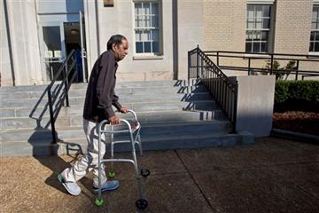(AP Photo/Brynn Anderson). Sureshbhai Patel steadies himself with a walker as he arrives at the federal courthouse before start of a trial against Madison, Ala., police officer Eric Sloan Parker, Tuesday, Sept. 1, 2015, in Huntsville, Ala. Patel, who w...