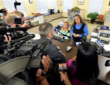 (AP Photo/Timothy D. Easley). Rowan County Clerk Kim Davis, right, talks with David Moore following her office's refusal to issue marriage licenses at the Rowan County Courthouse in Morehead, Ky., Tuesday, Sept. 1, 2015. Although her appeal to the U.S....