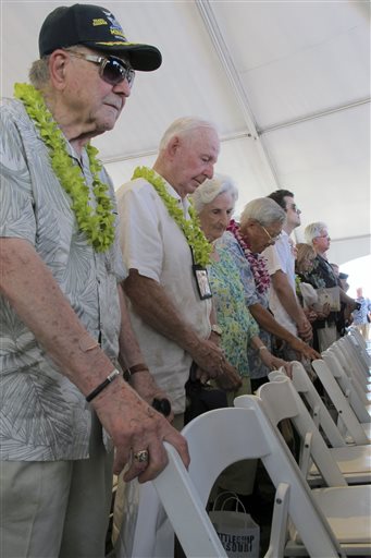 (AP Photo/Audrey McAvoy). Veterans and their families bow their heads during a ceremony marking the 70th anniversary of the end of World War II, Wednesday, Sept. 2, 2015 in Pearl Harbor, Hawaii. The veterans gathered on board the decomissioned battlesh...