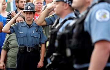 (AP Photo/Nam Y. Huh). A police explorer salutes as police officials follow Fox Lake Police Lt. Charles Joseph Gliniewicz's family after a vigil at Lakefront Park to honor him on Wednesday, Sept. 2, 2015, in Fox Lake, Ill. Gliniewicz was shot and kille...