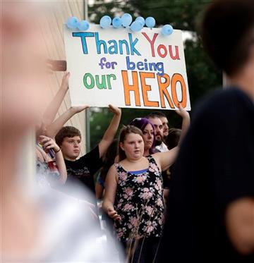 (AP Photo/Nam Y. Huh). Mourners hold a sign during a vigil at Lakefront Park to honor the memory of Fox Lake Police Lt. Charles Joseph Gliniewicz on Wednesday, Sept. 2, 2015, in Fox Lake, Ill. Gliniewicz was shot and killed Tuesday while pursuing a gro...