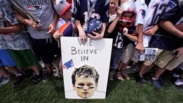 (AP Photo/Charles Krupa, File). FILE - In this July 30, 2015, file photo, New England Patriots fans wait for practice to complete, while standing behind a sign supporting quarterback Tom Brady, during an NFL football training camp in Foxborough, Mass. ...