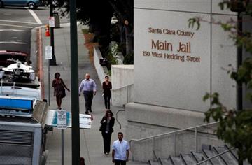 (/San Jose Mercury News via AP). In this photo taken, Wednesday Sept. 2, 2015, pedestrians walk past the Santa Clara County Jail in San Jose, Calif. Three California correctional deputies have been arrested on suspicion of murder in the death of an inm...