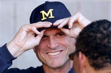 (AP Photo/Rick Bowmer). Michigan head coach Jim Harbaugh smiles after walking out to the field before the start of their  NCAA college football game against Utah, Thursday, Sept. 3, 2015, in Salt Lake City.