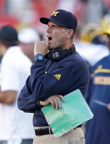 (AP Photo/Rick Bowmer). Michigan head coach Jim Harbaugh shouts to his team in the first quarter of an NCAA college football game against Utah, Thursday, Sept. 3, 2015, in Salt Lake City.