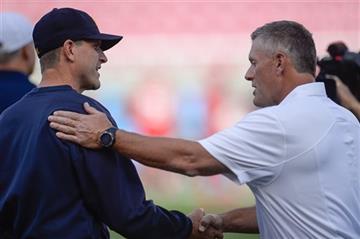 (Francisco Kjolseth/The Salt Lake Tribune via AP). Michigan coach Jim Harbaugh shakes hands with Utah coach Kyle Whittingham before the start of their NCAA college football game Salt Lake City on Thursday, Sept. 3, 2015.  DESERET NEWS OUT LOCAL TV OUT ...