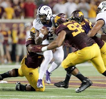 (92) and another defender during the first half of an NCAA college football game Thursday, Sept. 3, 2015, in Minneapolis. AP Photo/Paul Battaglia). TCU quarterback Trevone Boykin (2) is tackled for a 5-yard loss by Minnesota defensive lineman Robert Nd...