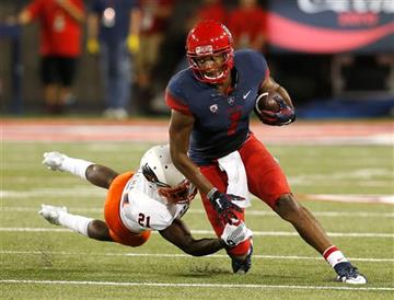 (AP Photo/Rick Scuteri). Arizona wide receiver Cayleb Jones (1) breaks the tavkle on UTSA cornerback Bennett Okotcha during the first half of an NCAA college football game, Thursday, Sept. 3, 2015, in Tucson, Ariz.