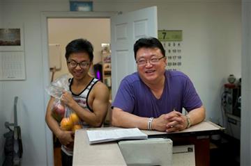 (AP Photo/Jae C. Hong). In this Tuesday, July 14, 2015 photo, pastor Young Ho Han, right, shares a light moment with recovering drug addict Steve Yoo at Nanoom Christian Fellowship, a drug rehab for Korean Americans, in Los Angeles. In a blue-and-white...