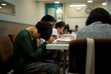 (AP Photo/Jae C. Hong). In this Wednesday, Aug. 5, 2015 photo, Inhui Bak, left, prays for her son, Daniel, along with other parents of drug addicts during a parent meeting at Nanoom Christian Fellowship, a drug rehab for Korean Americans, in Los Angele...