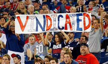 (AP Photo/Winslow Townson). New England Patriots fans hold a sign that refers to Patriots quarterback Tom Brady in the first half of an NFL football game between the Patriots and the New York Giants Thursday, Sept. 3, 2015, in Foxborough, Mass. Federal...