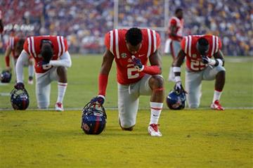 (AP Photo/Gerald Herbert, File). FILE - In this Oct. 25, 2014, file photo, Mississippi players pray in the end zone before an NCAA college football game against LSU in Baton Rouge, La. A football season begins, and with it comes religion on the gridiro...