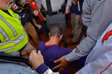 (AP Photo/Richard Shiro, File). FILE - In this Nov. 29, 2014, file photo, Clemson head coach Dabo Swinney kneels and prays after an NCAA college football game against South Carolina in Clemson, S.C. A football season begins, and with it comes religion ...