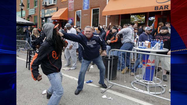 A protestor, left, fights with a bar patron outside.  (AP Photo/Patrick Semansky) of a bar near Oriole Park at Camden Yards